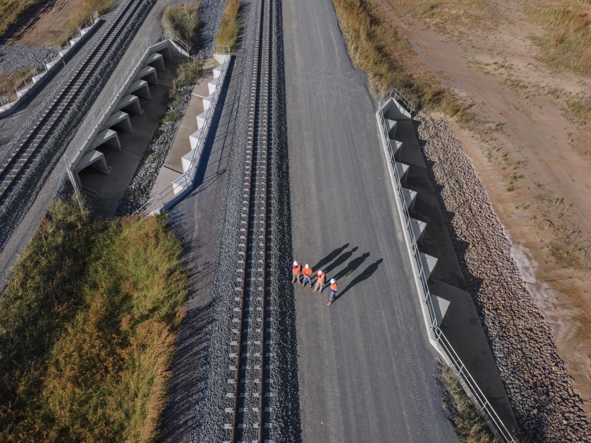 A Yellow Excavator Is Breaking Concrete on A Construction Site — Hillery Group in Bowen, QLD