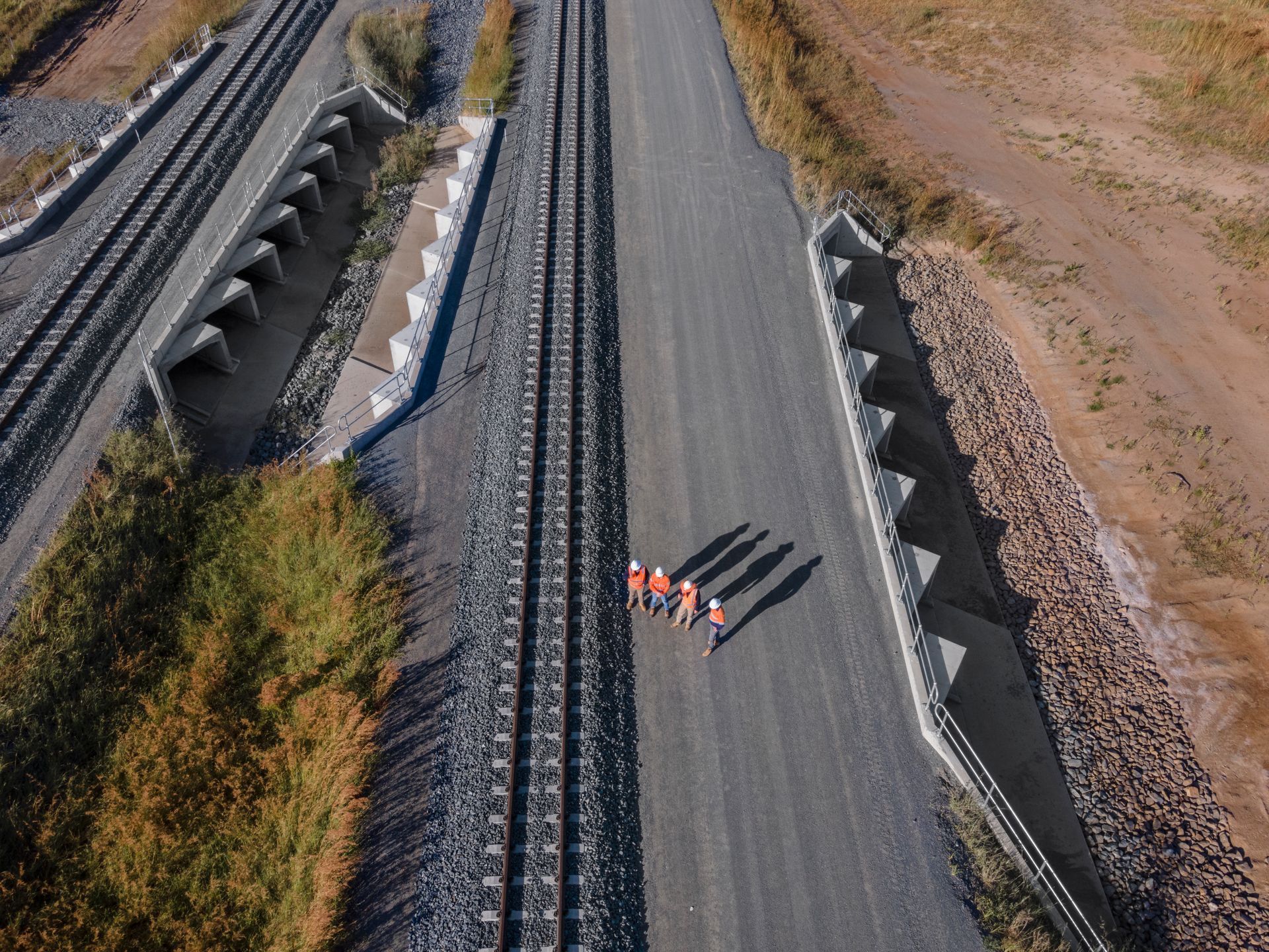 A Man in A Suit and Tie Is Holding a Hard Hat and Blueprints — Hillery Group in Bowen, QLD