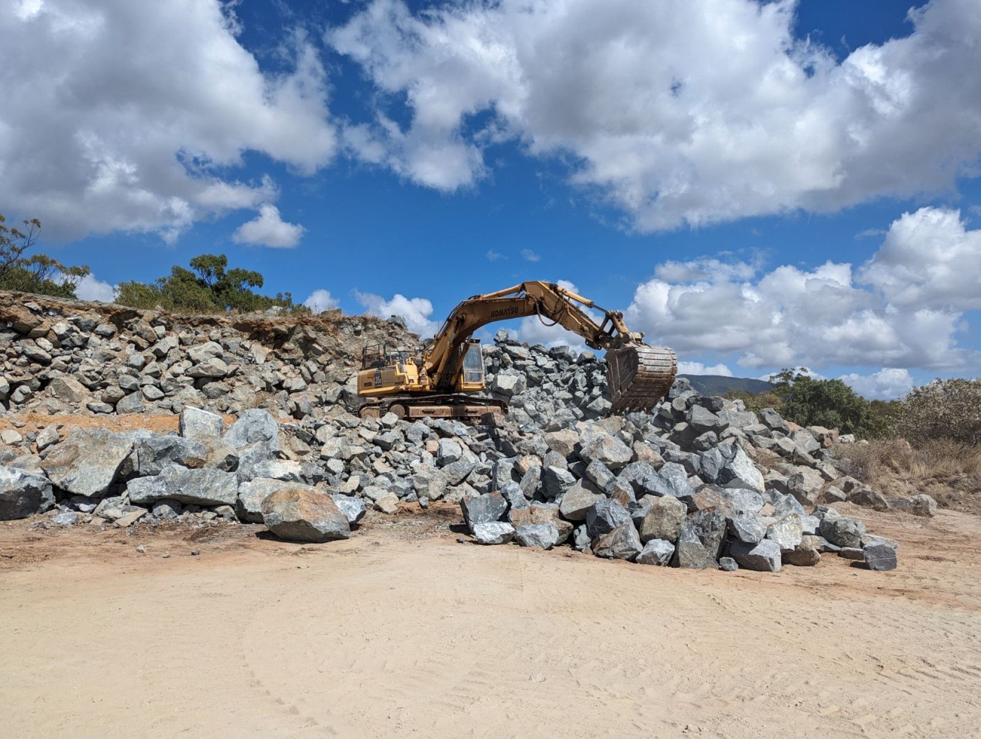 A Dump Truck Is Dumping Dirt Into a Hole — Hillery Group in Bowen, QLD