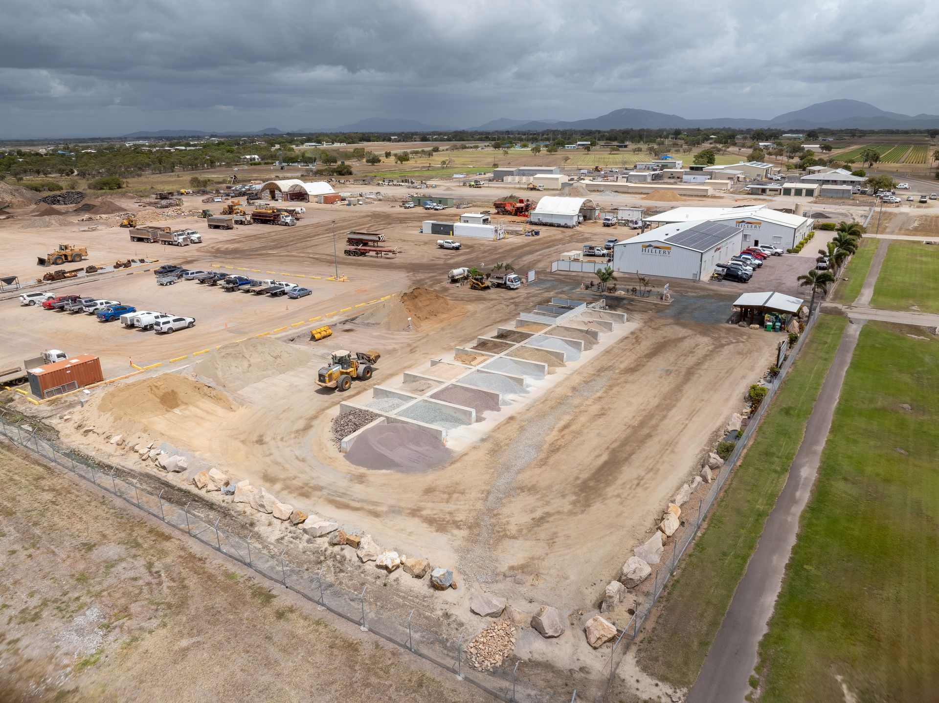 A Yellow Compactor Is Being Used to Compact Concrete on A Construction Site — Hillery Group in Bowen, QLD