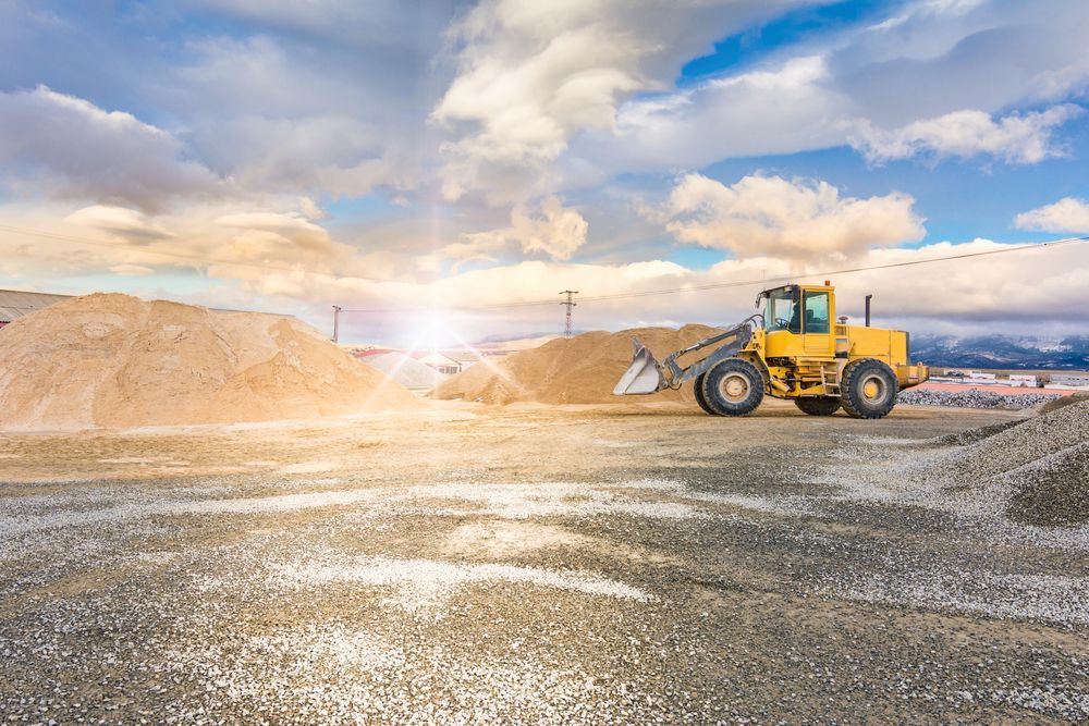 A Yellow Bulldozer is Driving Through a Dirt Field — Hillery Group in Inkerman, QLD