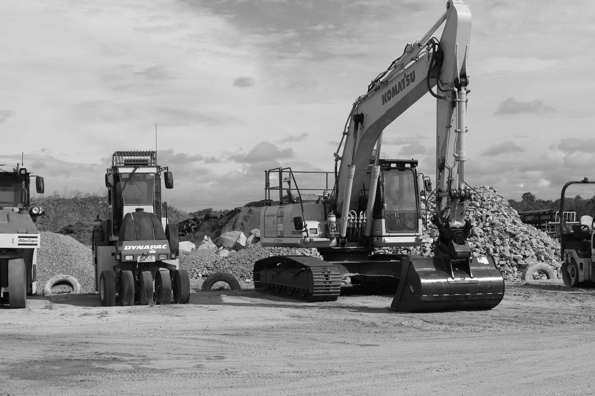 A Machine Is Drilling a Hole in The Ground in A Quarry — Hillery Group in Bowen, QLD