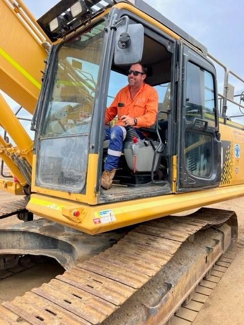 Man Driving a Digger — Hillery Group in Bowen, QLD