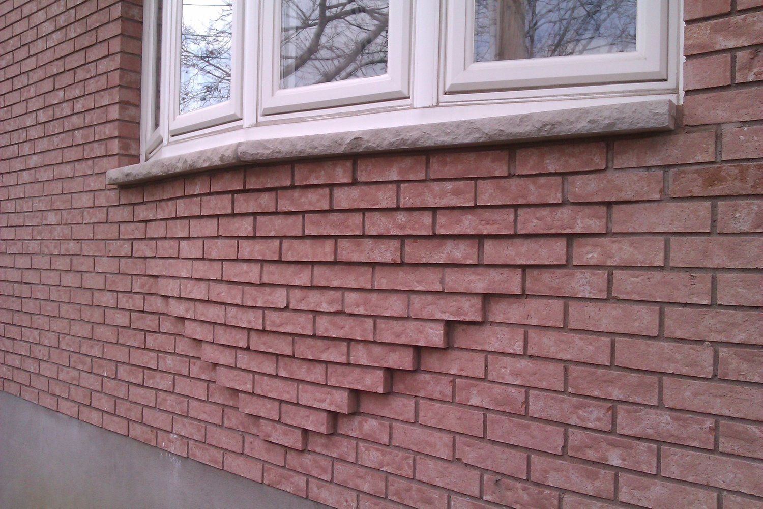 A brick wall with a window on it