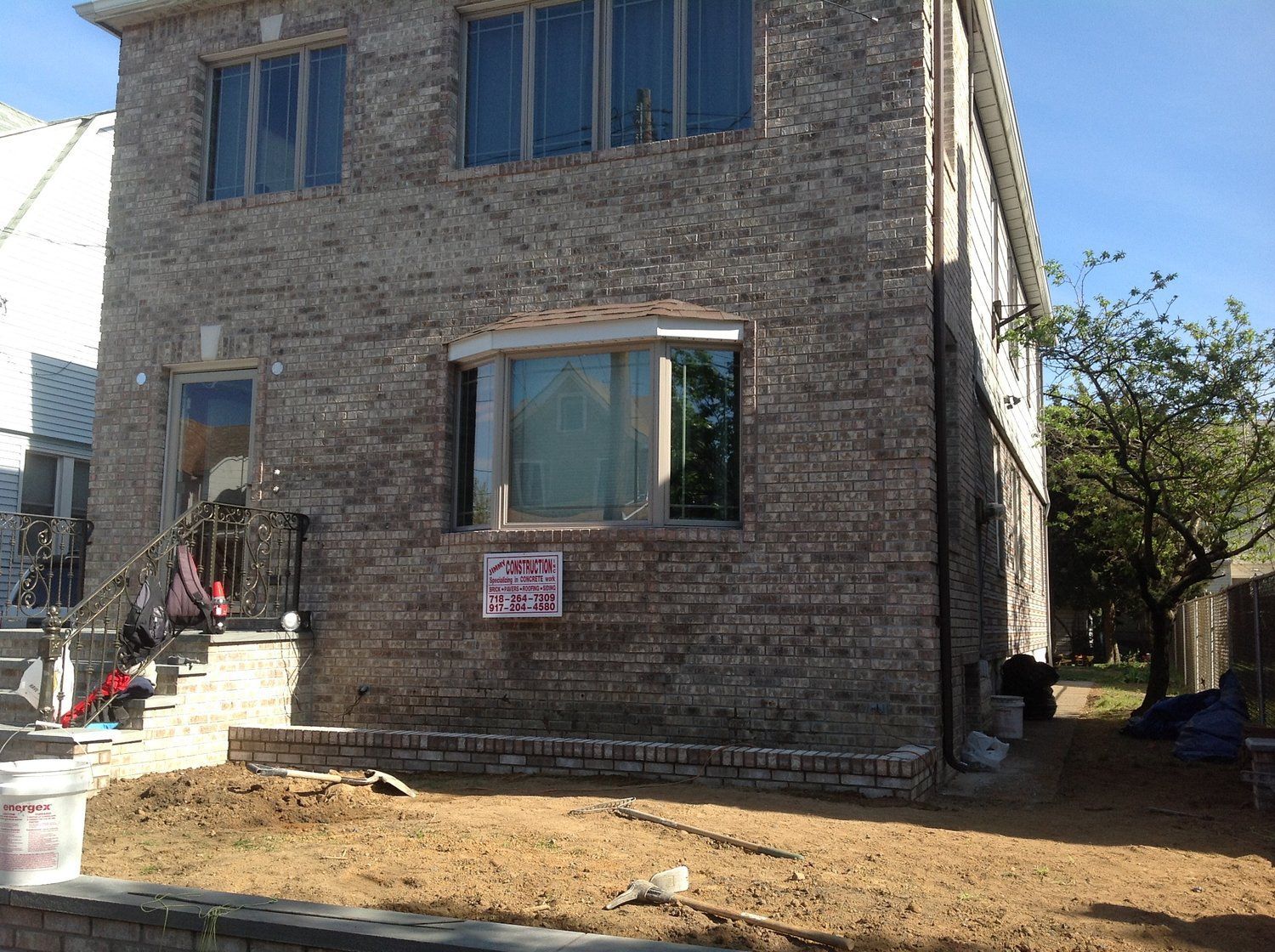 A large brick building with a for sale sign in front of it