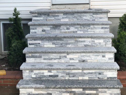 A set of stone stairs leading up to a house.