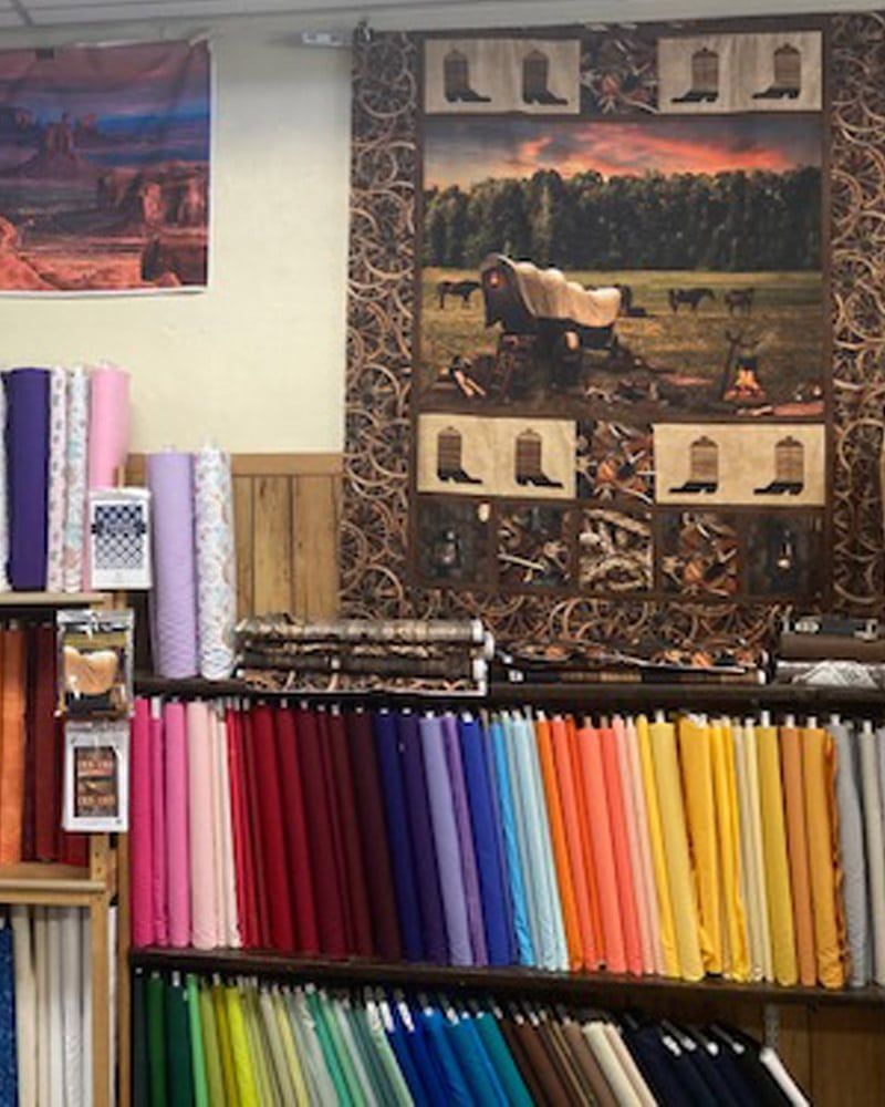 A store filled with lots of different colored fabrics