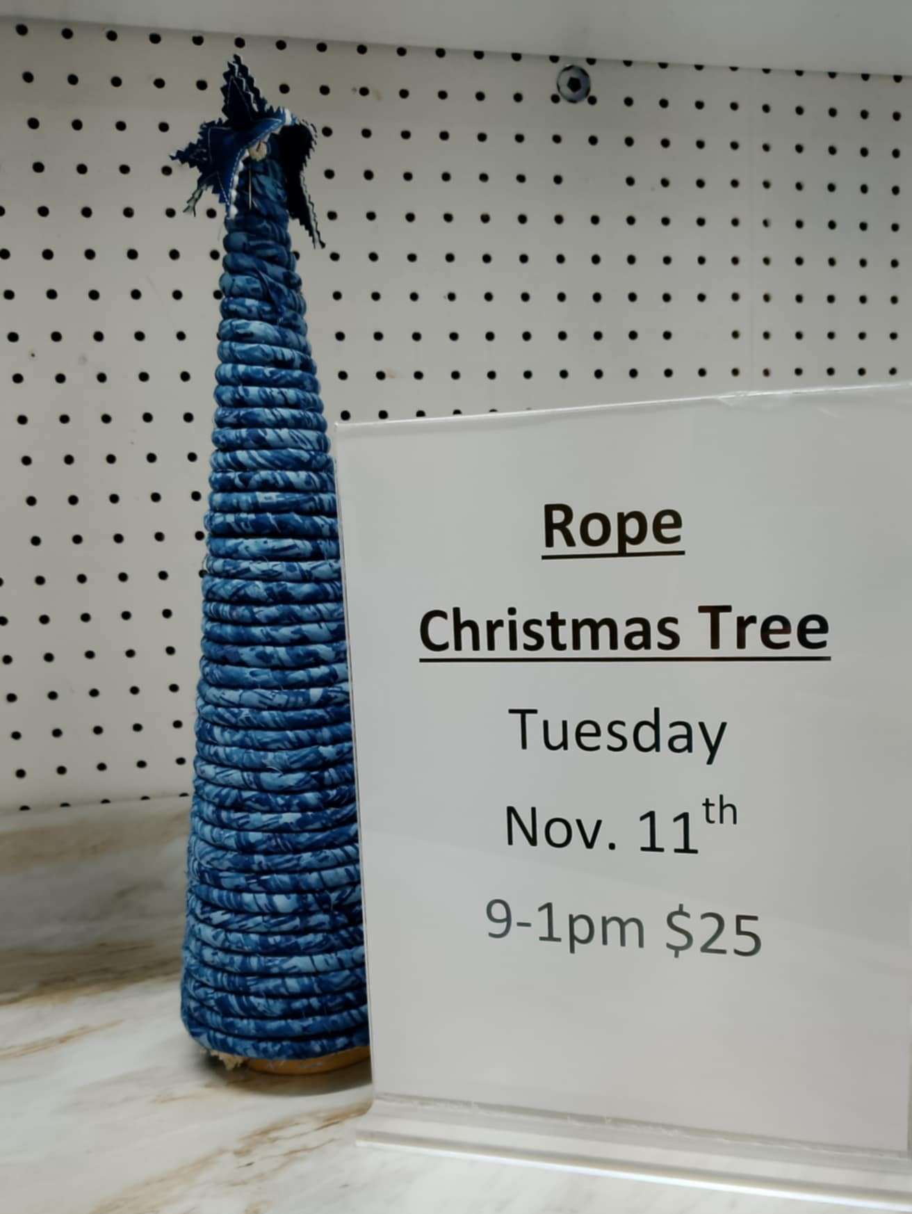 Quilted orange pumpkin with a carved face on blue background.