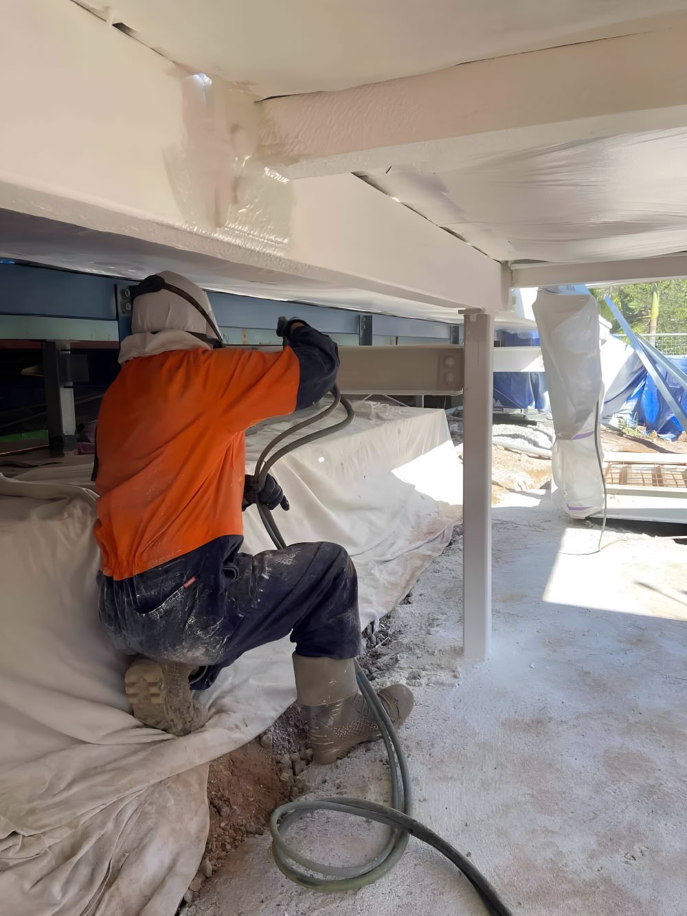 A Man Is Spraying — Waters Abrasive Blasting Services In Shaw, QLD