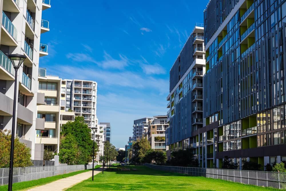 A Row of Apartment Buildings in a Residential Area With a Park in the Middle — Waters Abrasive Blasting Services In Shaw, QLD