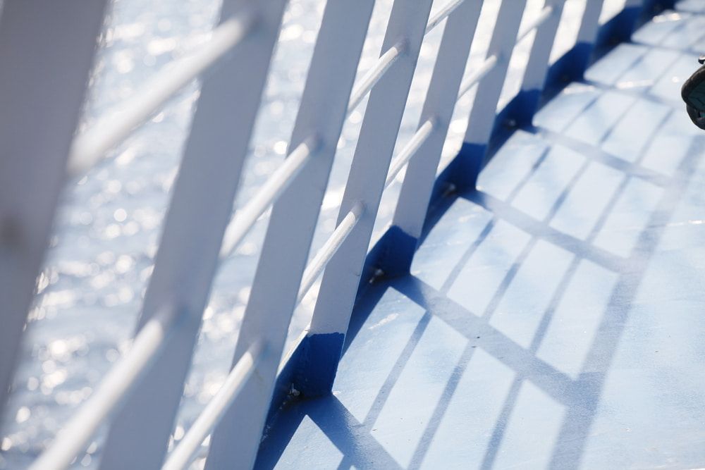 A Close Up of a White Railing With a Blue Border — Waters Abrasive Blasting Services In Shaw, QLD