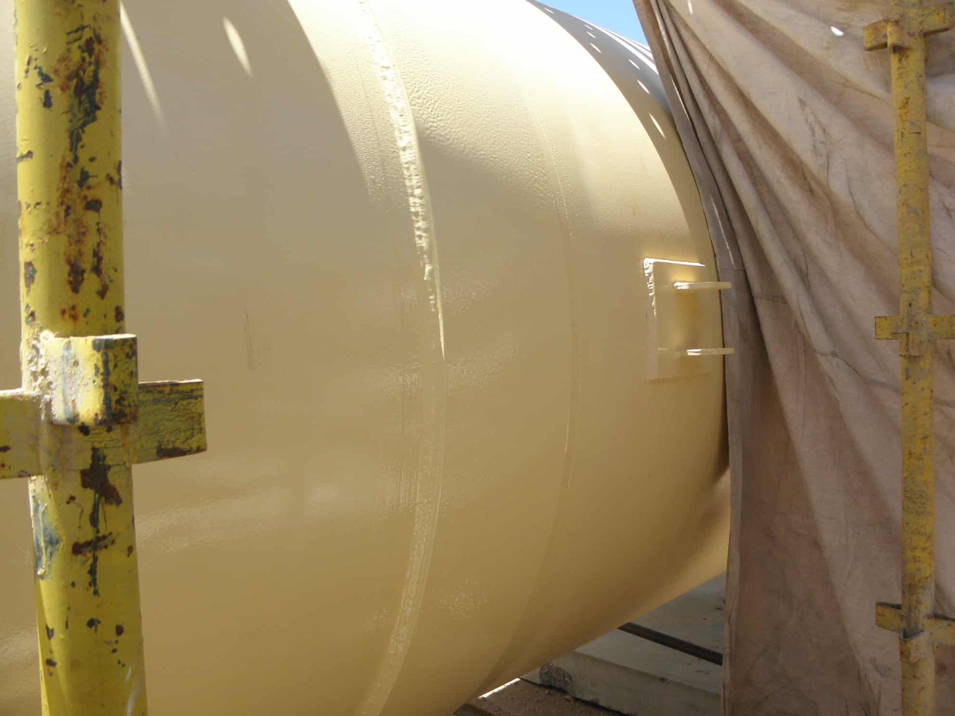 A Large White Object is Sitting on Top of a Yellow Scaffolding — Waters Abrasive Blasting Services In Shaw, QLD