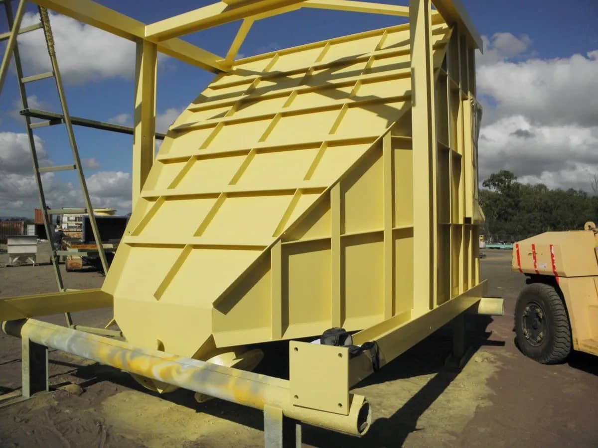 A Yellow Truck is Parked Next to a Large Yellow Structure — Waters Abrasive Blasting Services In Shaw, QLD