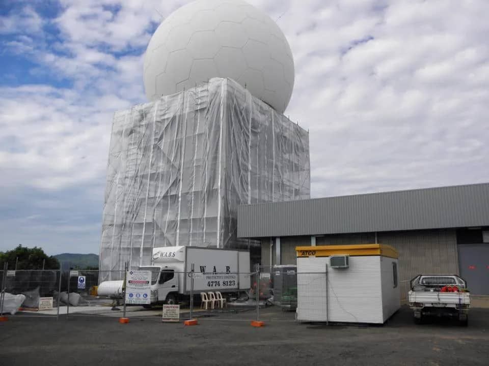 A Large White Sphere is Sitting in Front of a Building — Waters Abrasive Blasting Services In Shaw, QLD