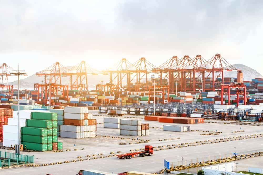 A Large Port Filled With Lots of Containers and Trucks — Waters Abrasive Blasting Services In Shaw, QLD