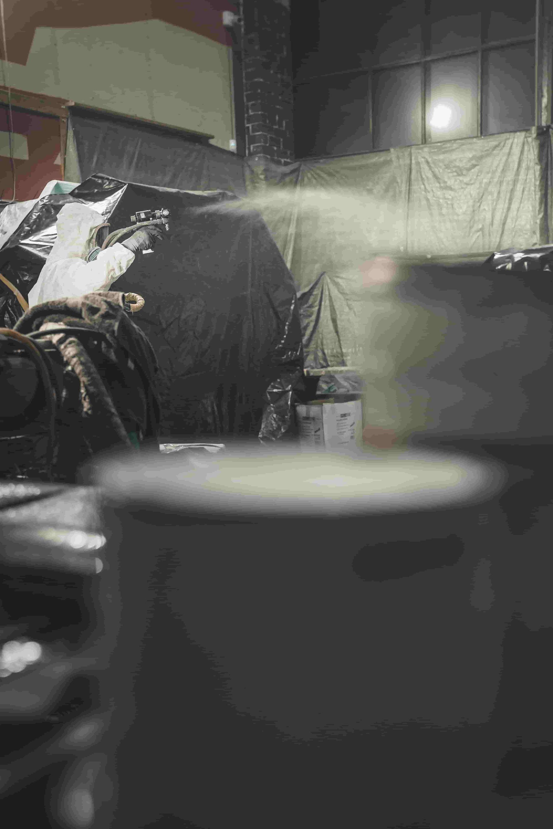 A Cup of Coffee is Sitting on a Table in a Dark Room — Waters Abrasive Blasting Services In Shaw, QLD