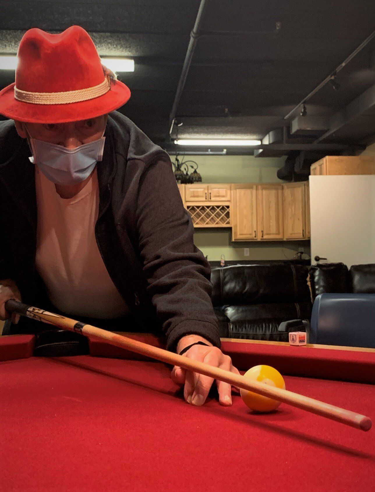 Senior Male in Red Fedora Shooting Pool