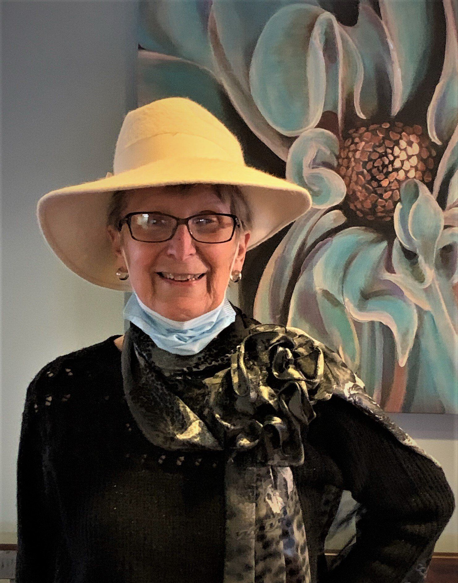 Senior Woman Wearing Big White Hat & Grey Scarf