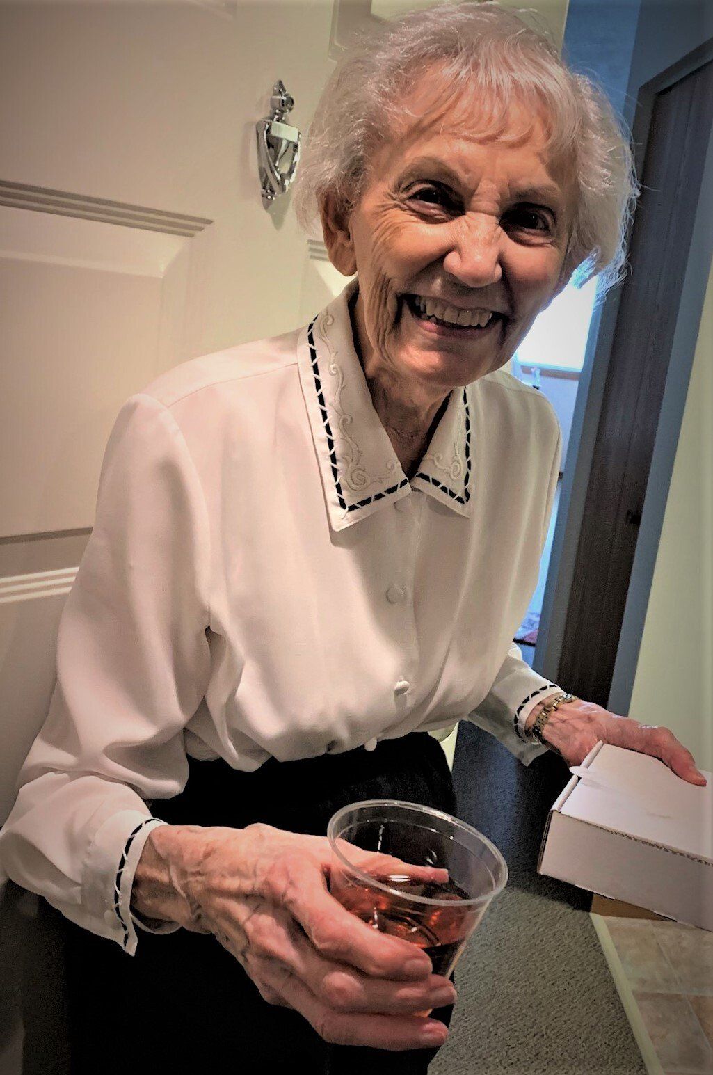 Happy Senior Woman with Cup of Wine
