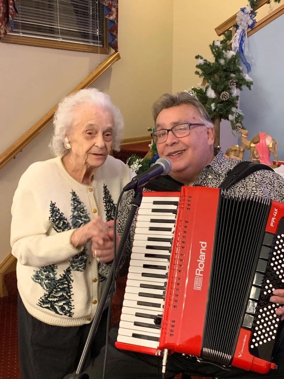 Man Playing Accordion & Singing with Senior Woman