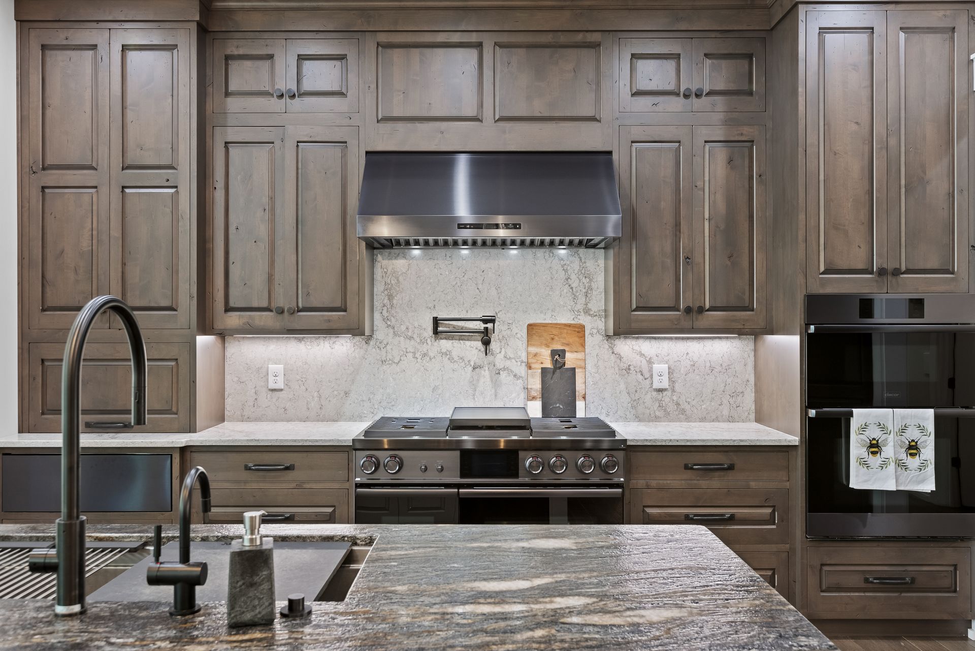 Kitchen with grey cabinets, stainless steel appliances, and a granite countertop.