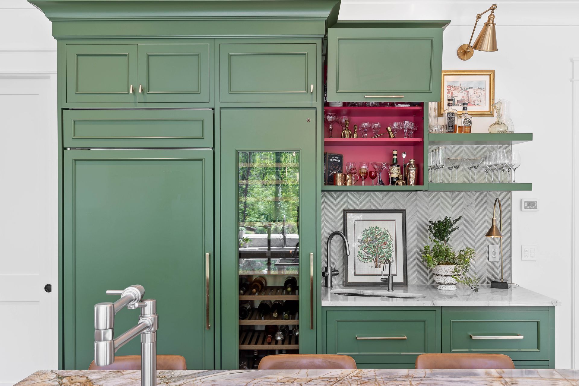Green kitchen cabinets with a wine cooler, sink, and open bar with pink interior.