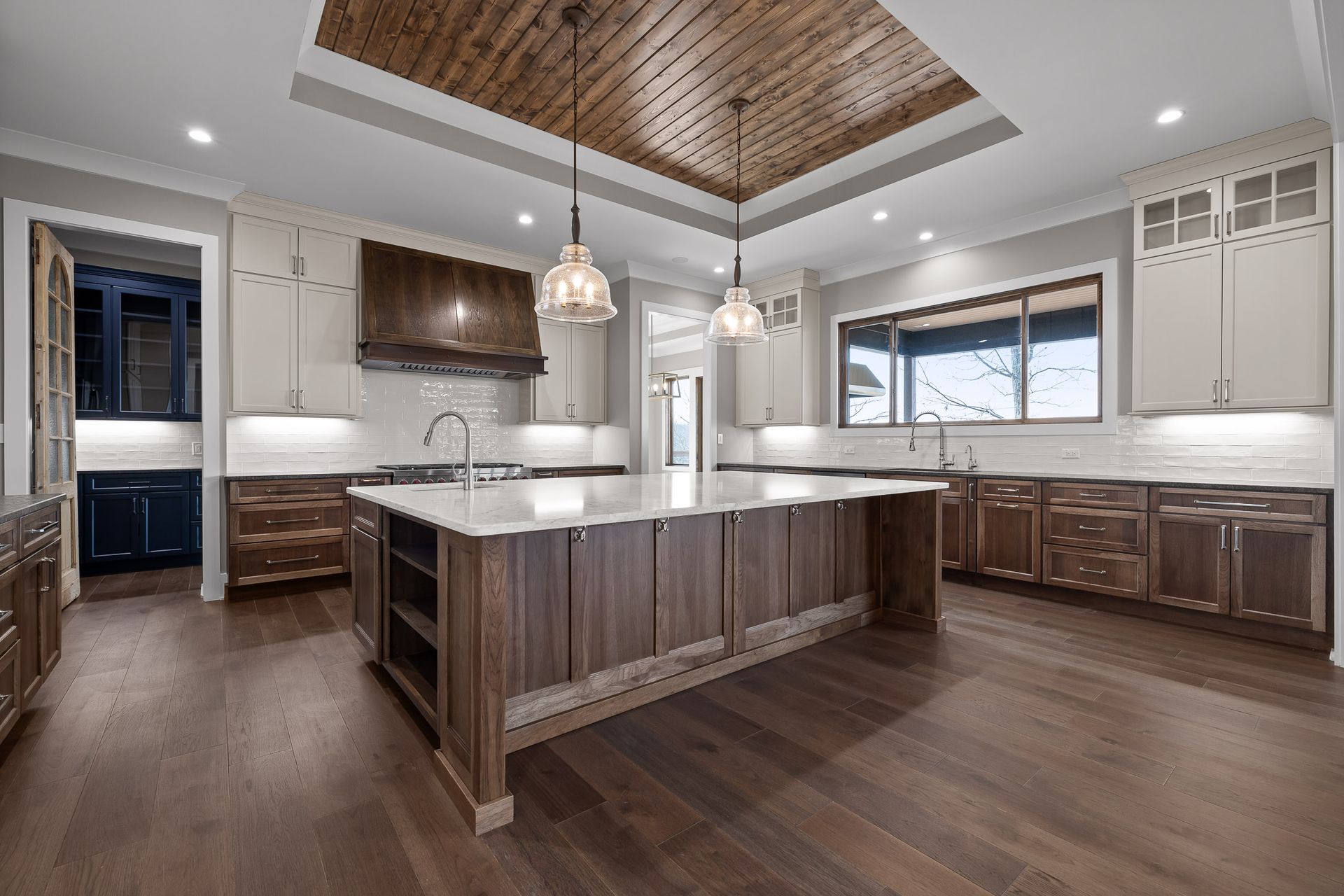 Kitchen with wood cabinets, large island, and wood ceiling.