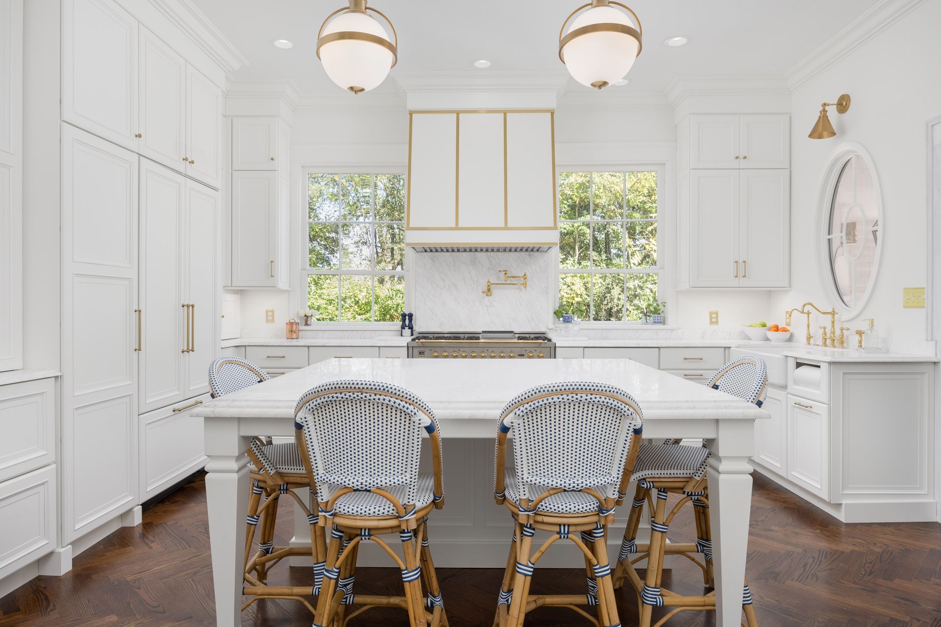 A kitchen with white cabinets and a large island in the middle.