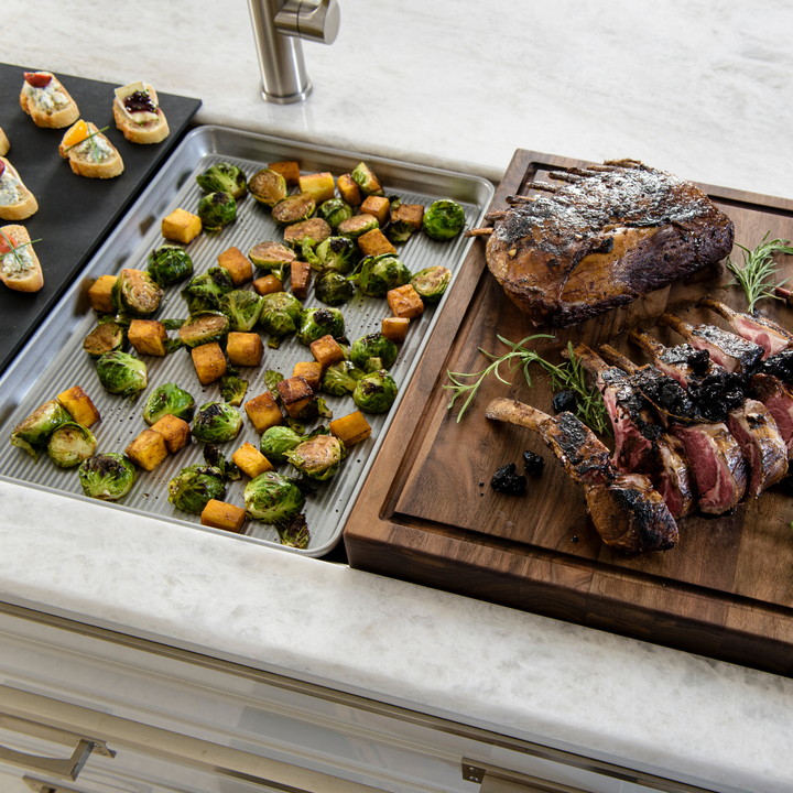 A wooden cutting board with meat and vegetables on it