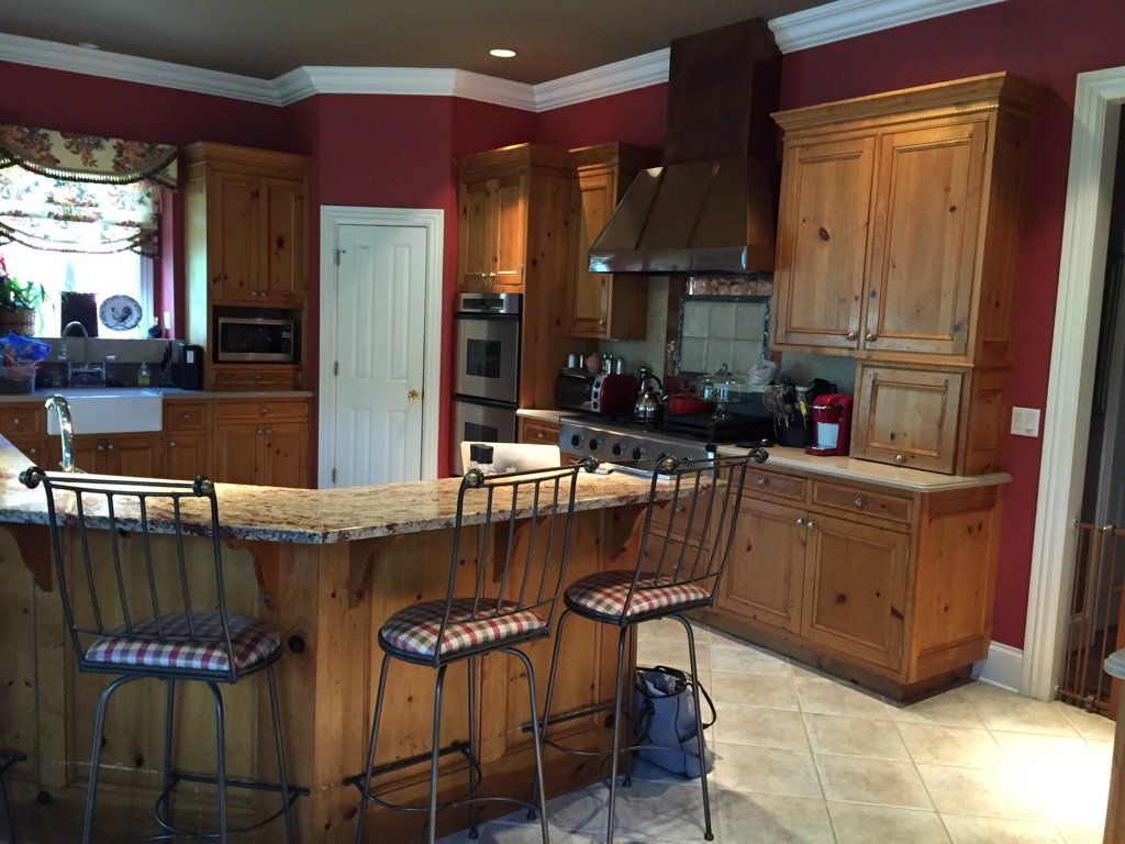 A kitchen with wooden cabinets and granite counter tops