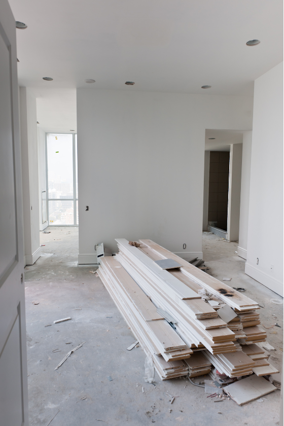 A room with a stack of wood on the floor