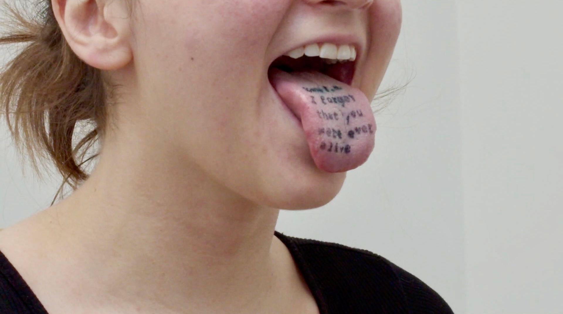 printed on the surface of a stuck out tongue are the words 