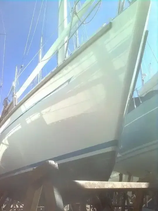 A White Sailboat is Sitting on a Dock — Baran Yachting in Coomera, QLD