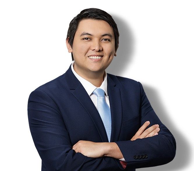 A man in a suit and tie is smiling for the camera.