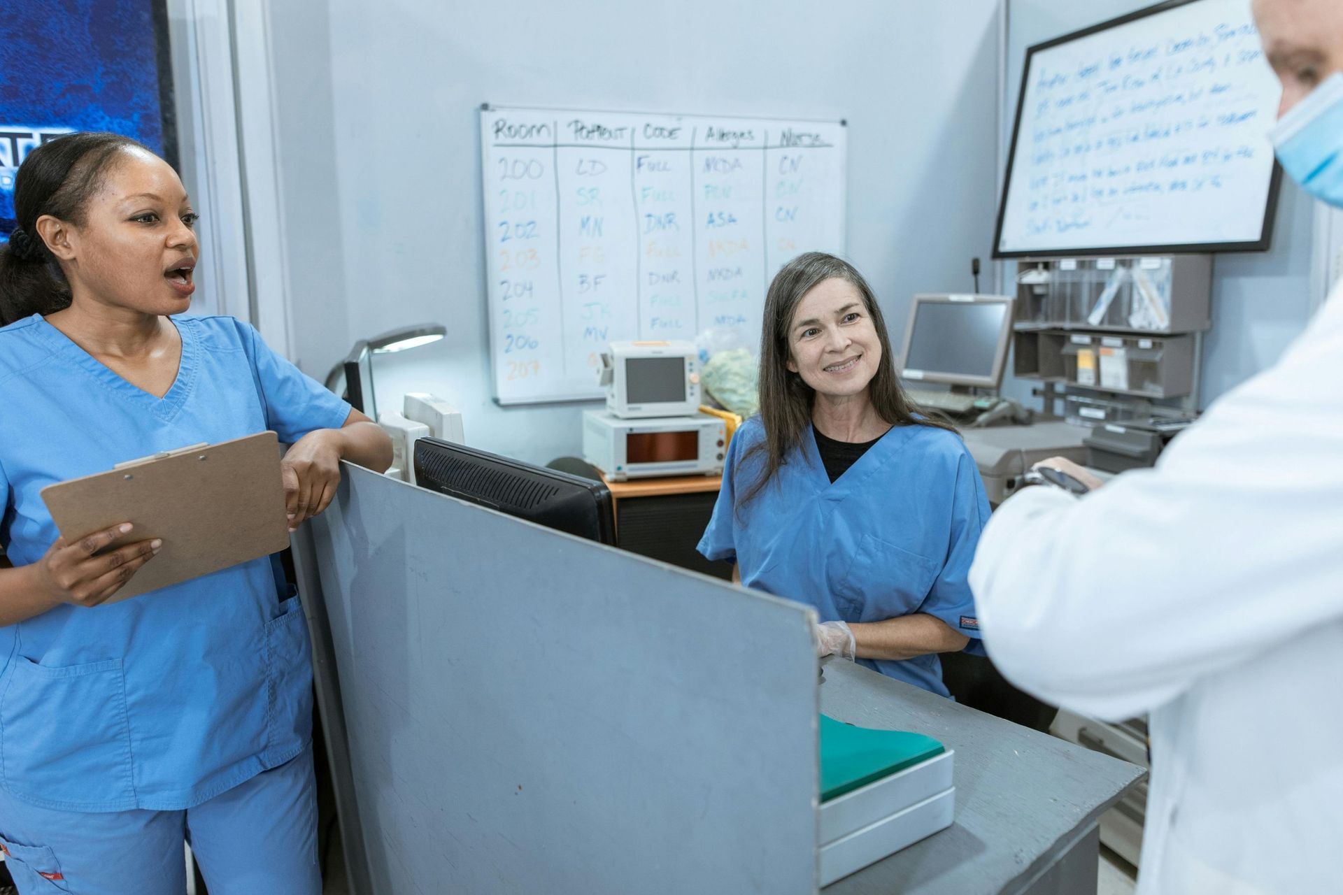 female nurses talking with doctor