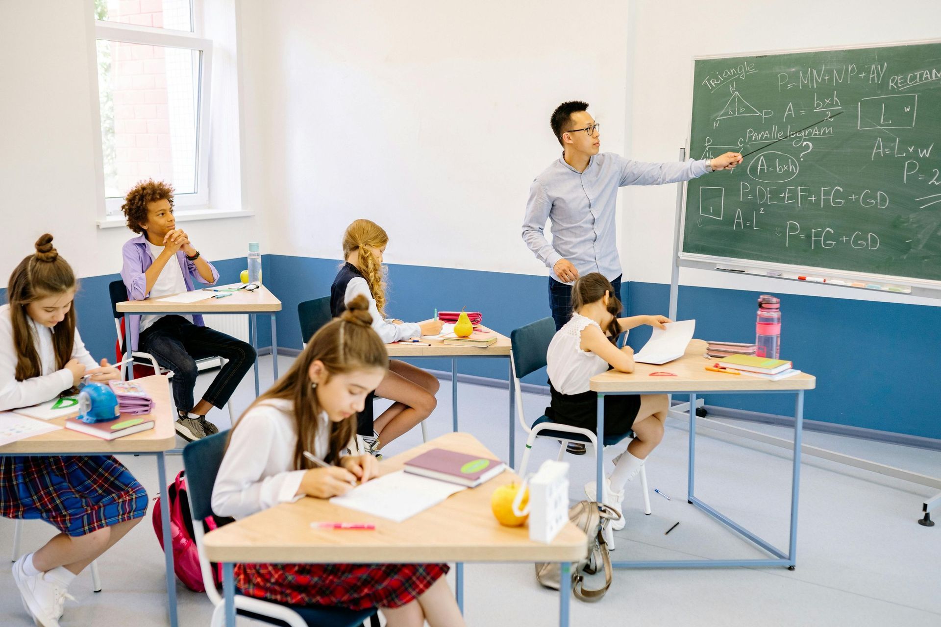 male teacher teaching infront of students