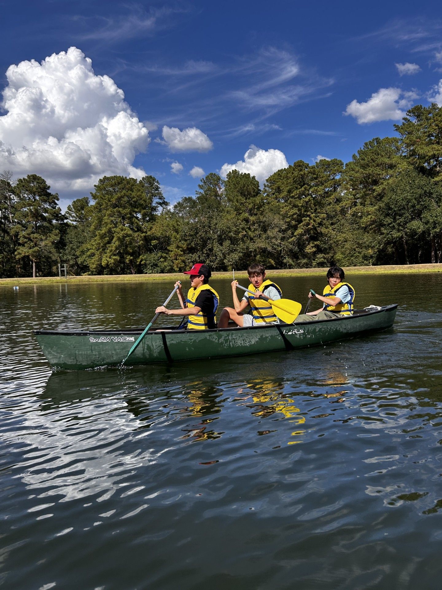 Three boys in a canoe.