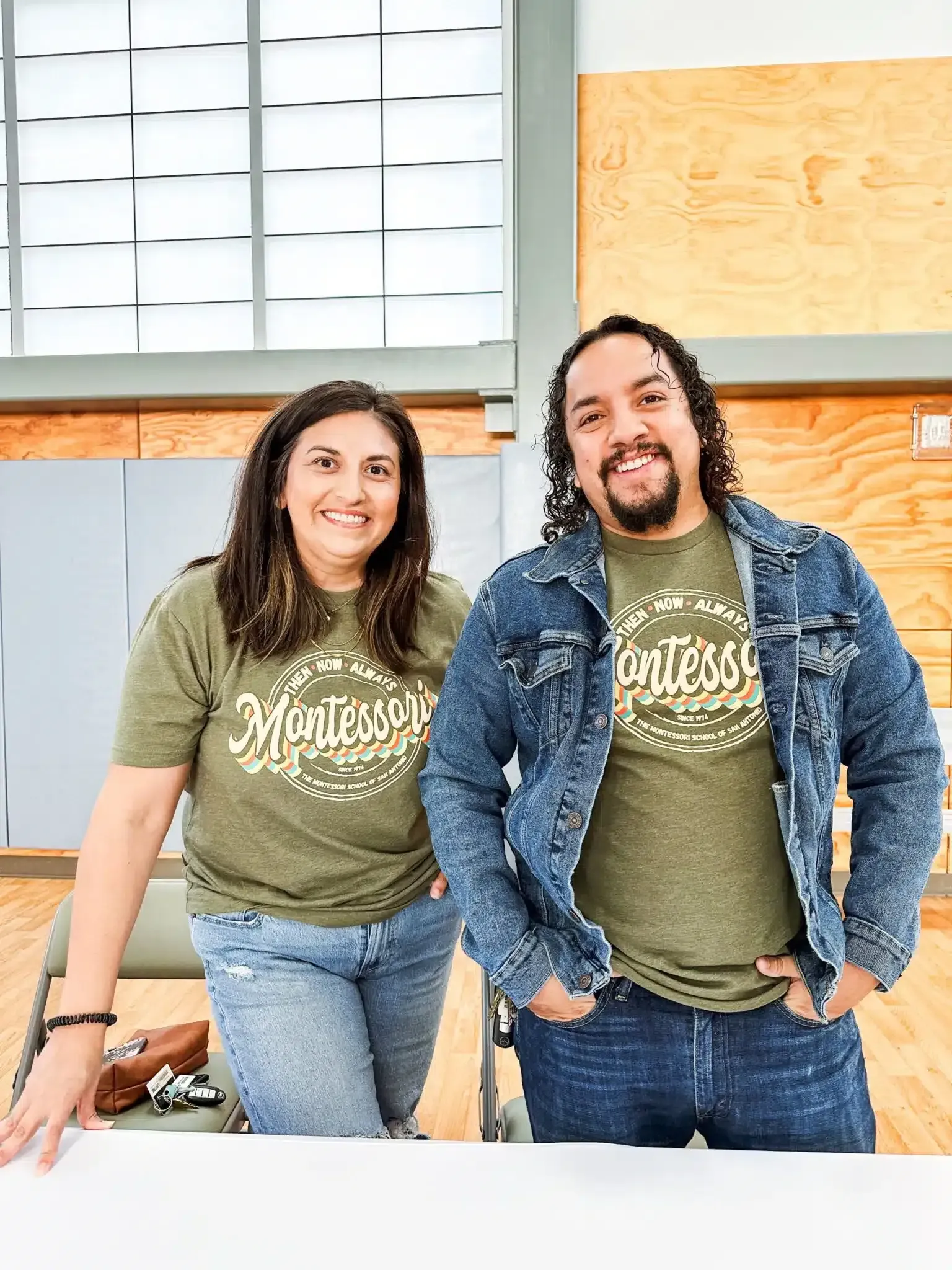 Two people stand inside; both wearing 