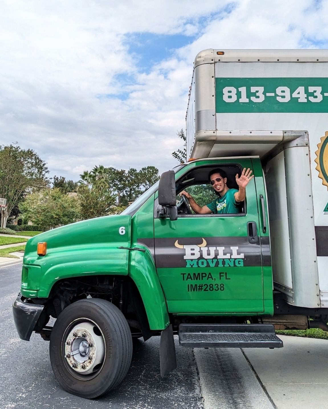 A Woman is Carrying a Cardboard Box - Tampa, FL - Bull Moving LLC