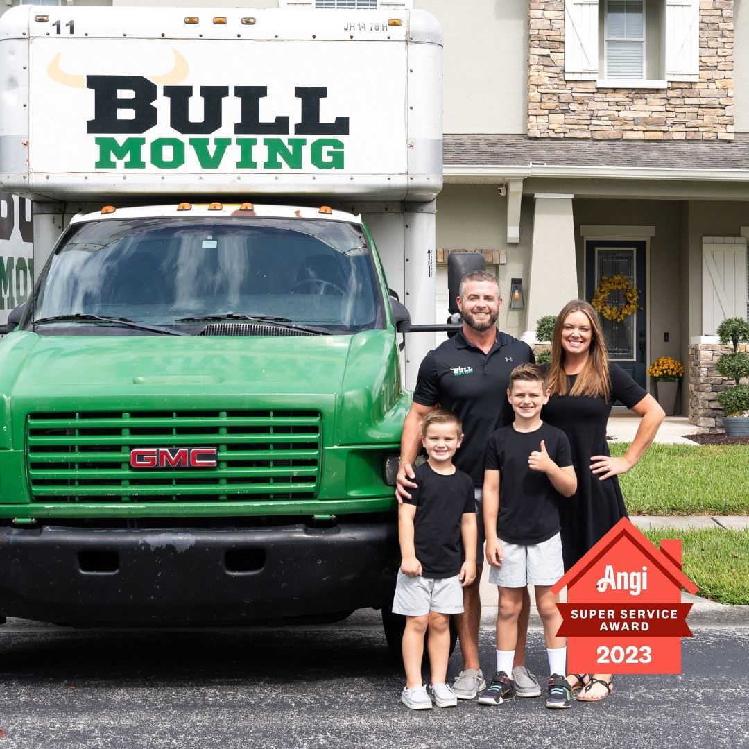 A Group of People Are Standing in Front of a Moving Truck - Tampa, FL - Bull Moving LLC