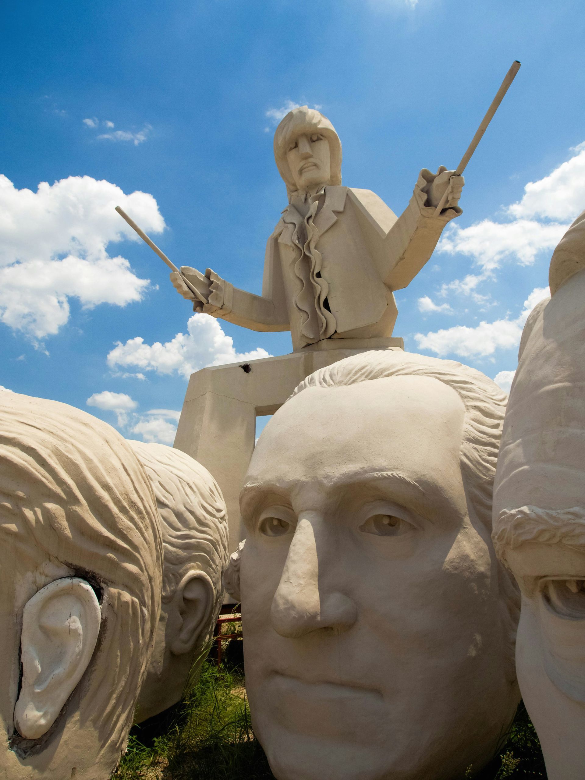 A statue of george washington is surrounded by other statues