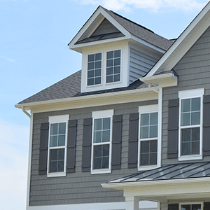 A gray house with white trim and black shutters