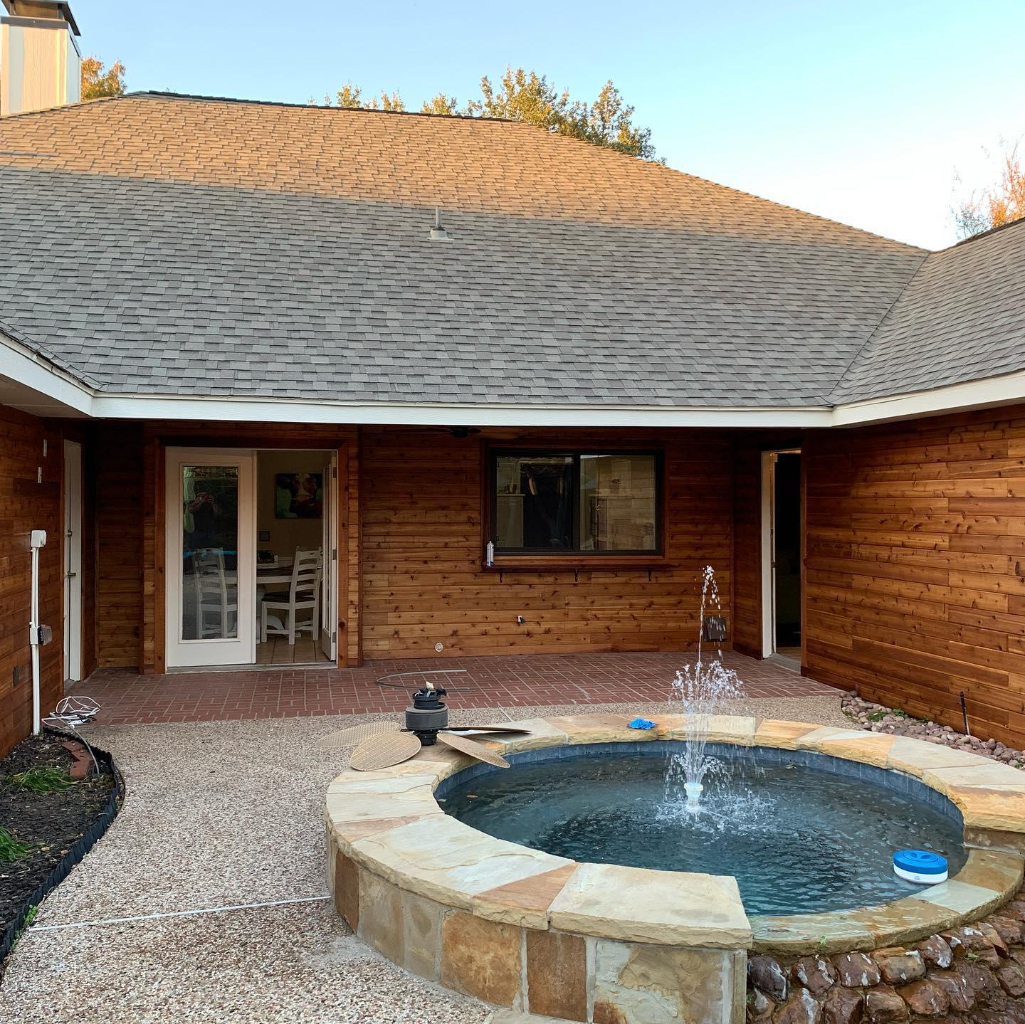 A house with a hot tub in front of it