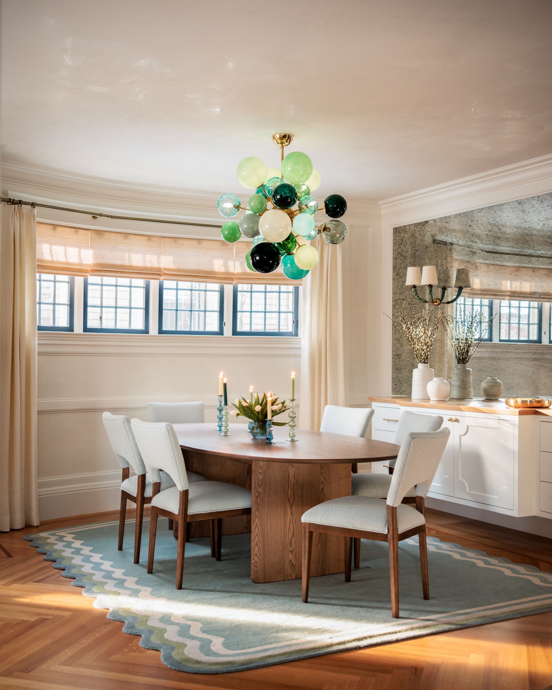 White curtains with woven wood shades in a casual dining area