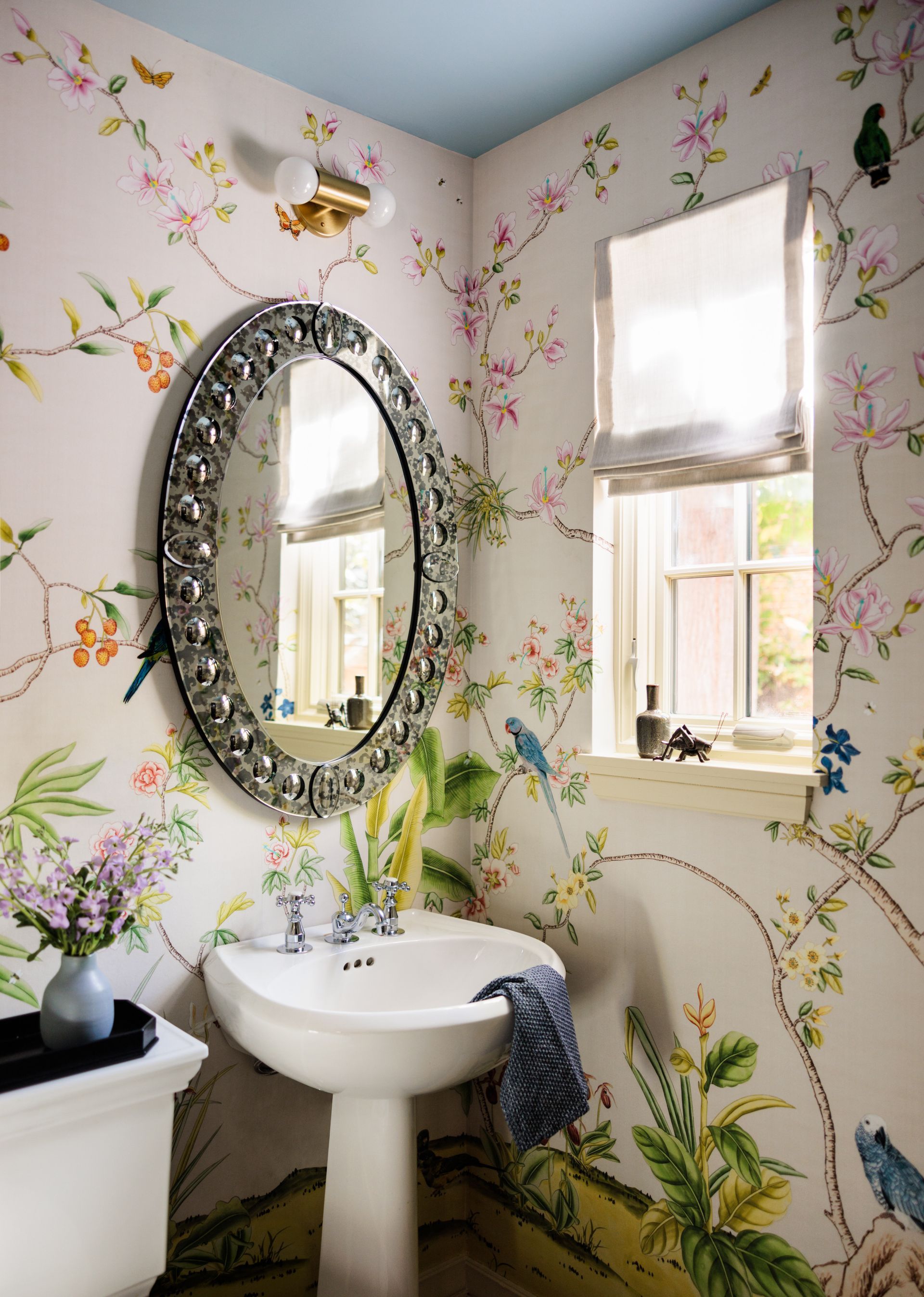 A bathroom with a sink a mirror and a window