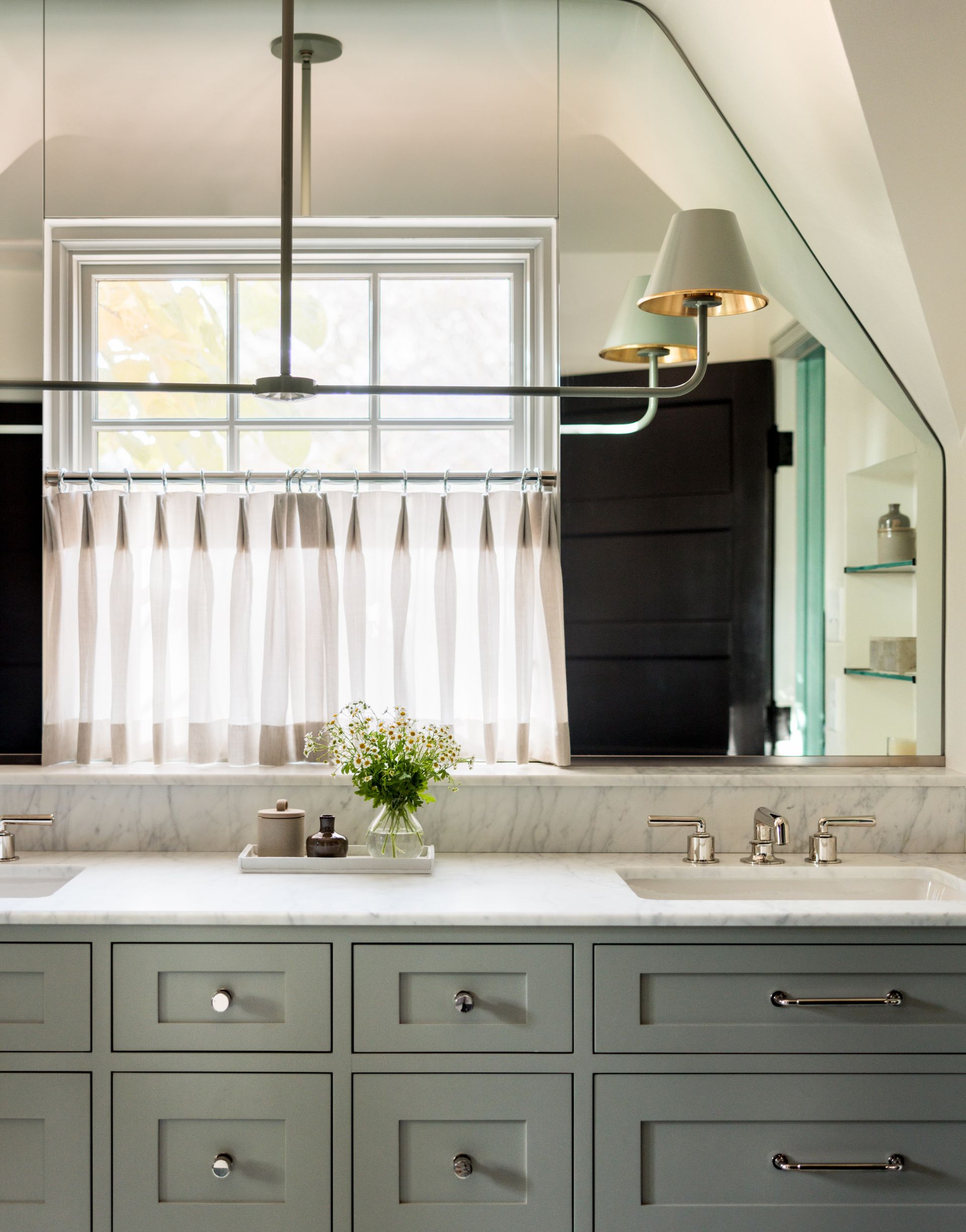A bathroom with a sink a mirror and a window