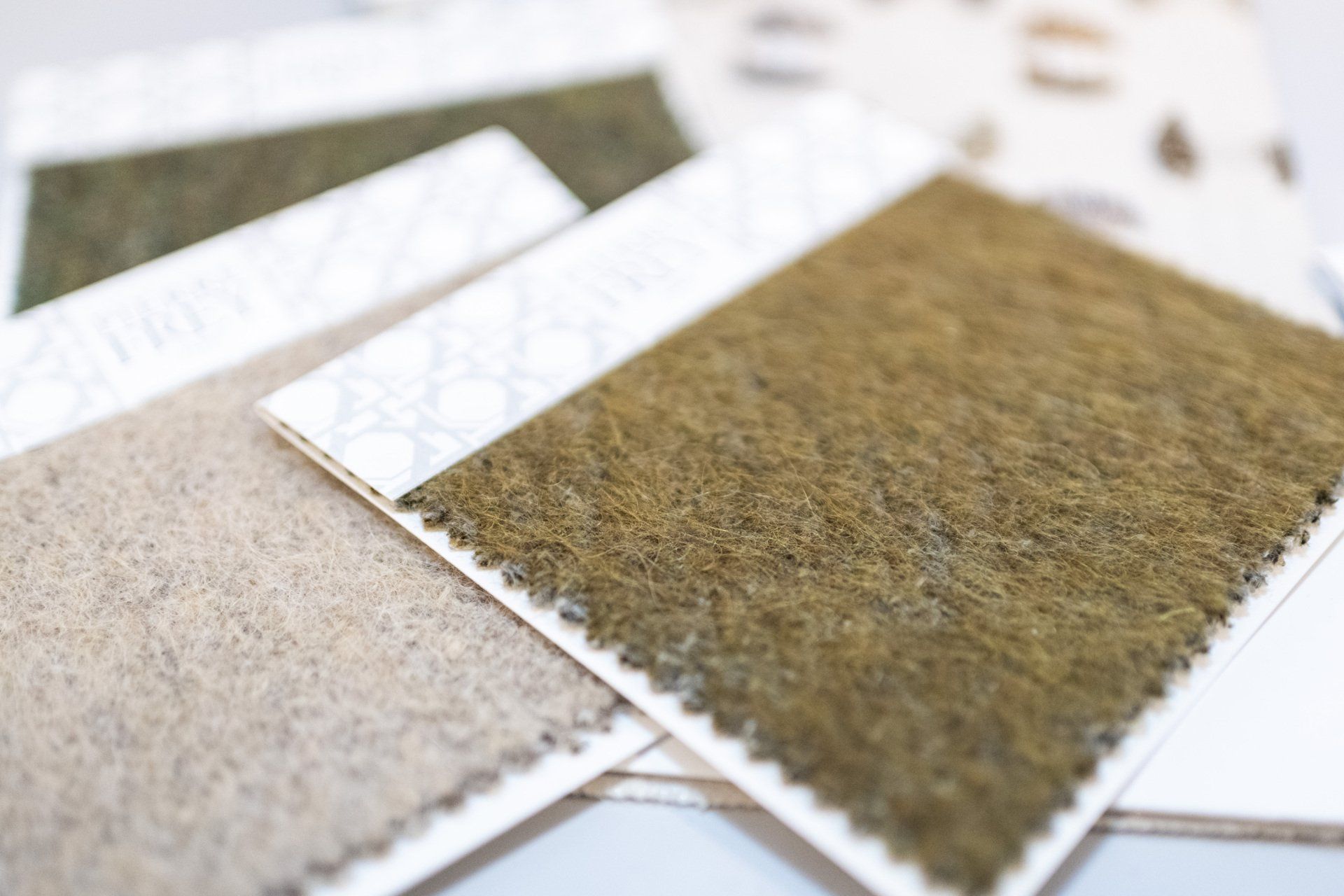 Several pieces of fabric swatches are stacked on top of each other