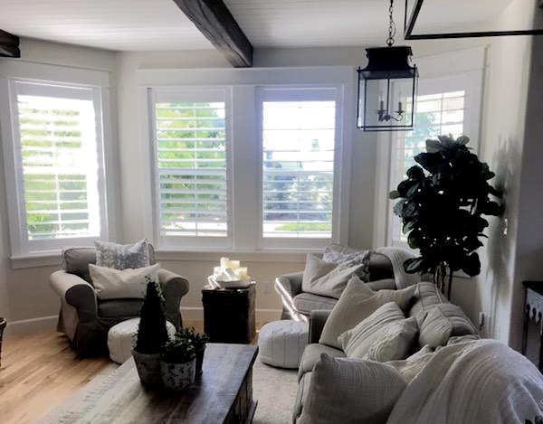 Custom and hand-crafted furniture Norman Shutters designed in living room window