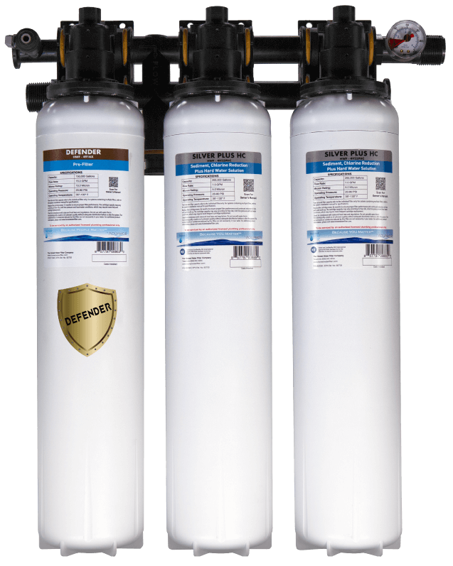 A water filter with three cartridges and a gauge attached to it.