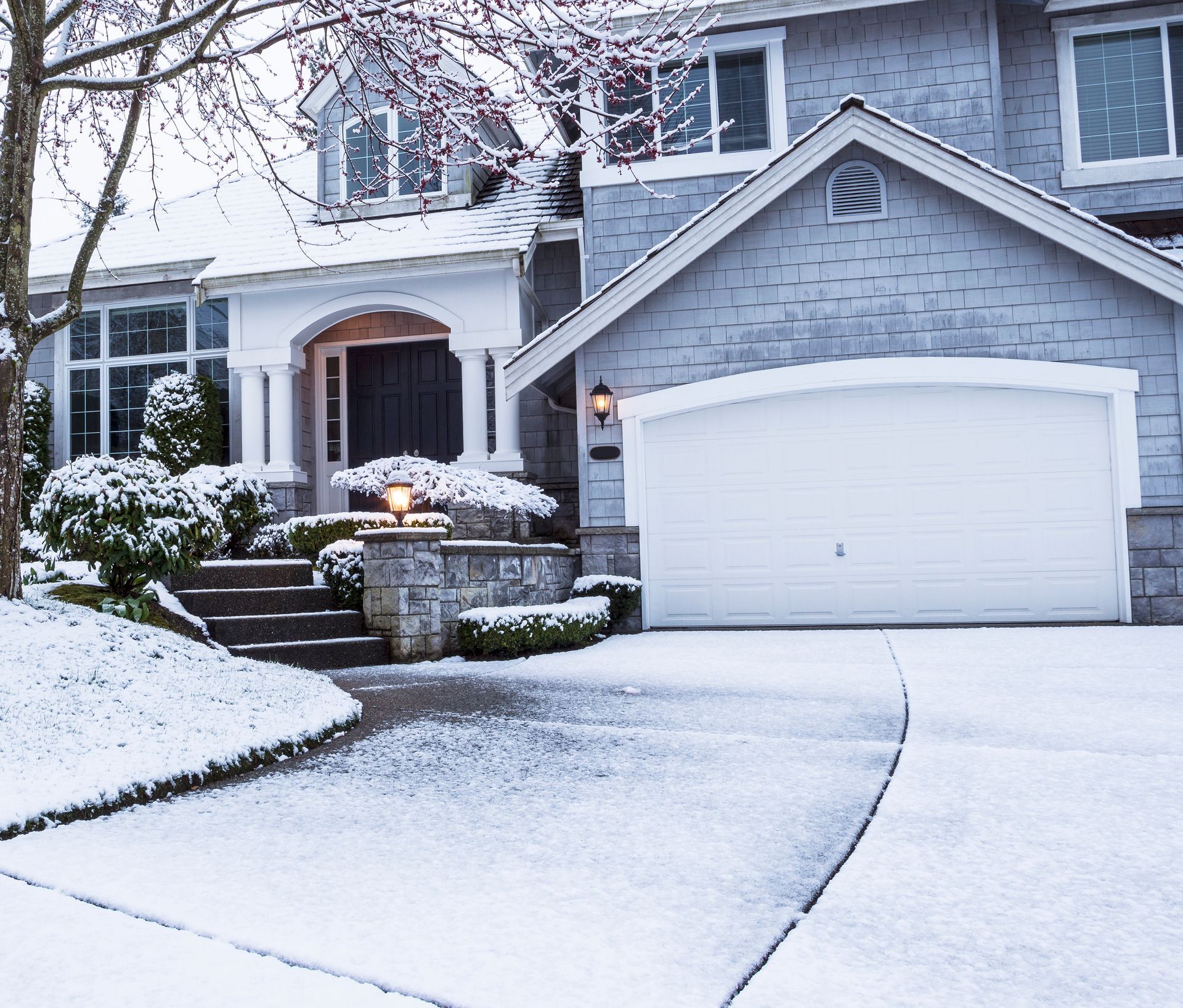 A home's landscaping covered by snow in the winter